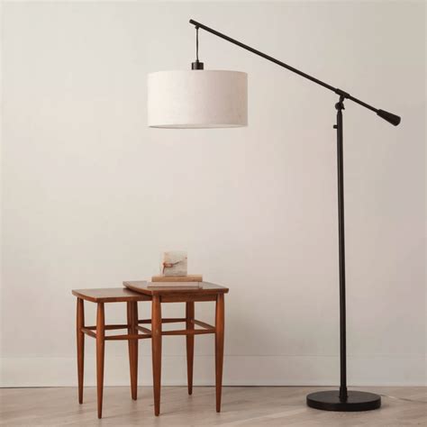 Description. This Torchiere with Task Light Floor Lamp from Room Essentials™ can be placed near an armchair, bedside or desk. It features an upward-facing white bowl shade that's attached to a slim metal stand with a pedestal base, and it comes with a fully adjustable reading light so that the light can be positioned where it's most needed. 